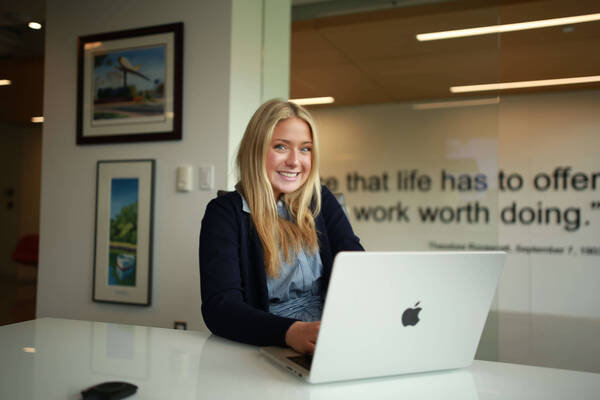 Maddy Hutson smiles for the camera during her work day.