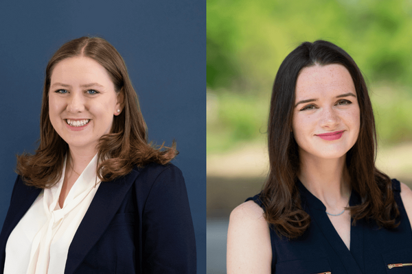 Two women, one with shoulder-length brown hair in a navy blazer and white blouse, and the other with long brown hair in a navy sleeveless top, are shown in a composite image.  The woman on the left is smiling against a dark blue background, while the woman on the right is smiling against a blurred green, outdoor background.