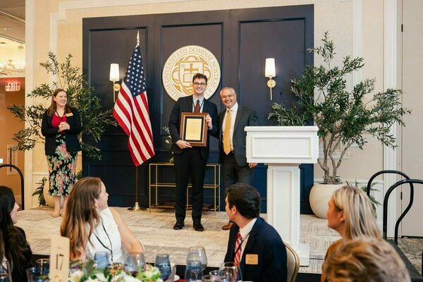 Luke Thompson with Prof. Munoz receiving an award.