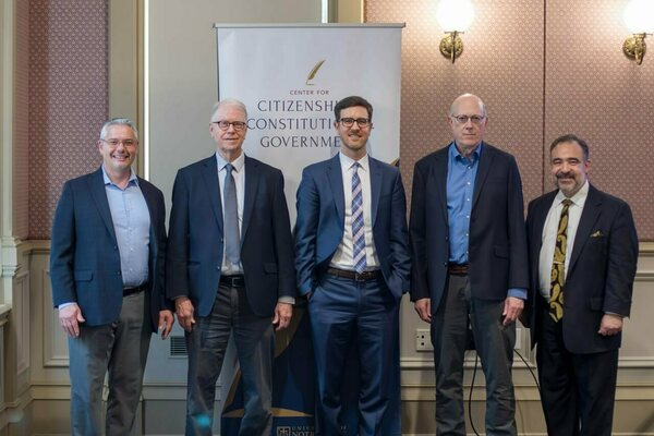 Five men in suits and blazers smile at the True Lecture Series