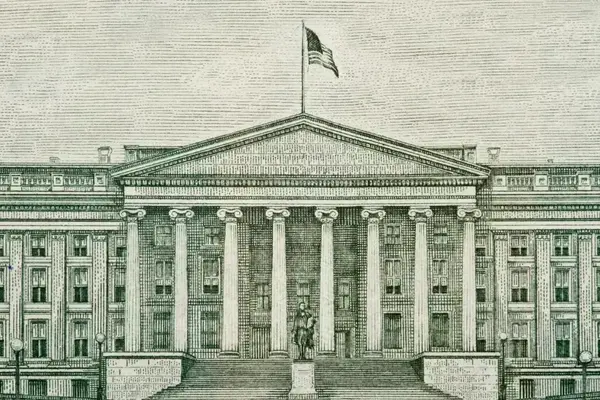 Engraved facade of the US Treasury Building with classical columns, a pediment, American flag, and Alexander Hamilton statue.
