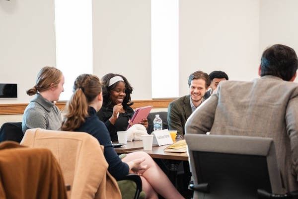 Tocqueville Fellows Featured Image of them at a colloquium laughing.